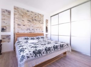 A built in wardrobe with sliding doors