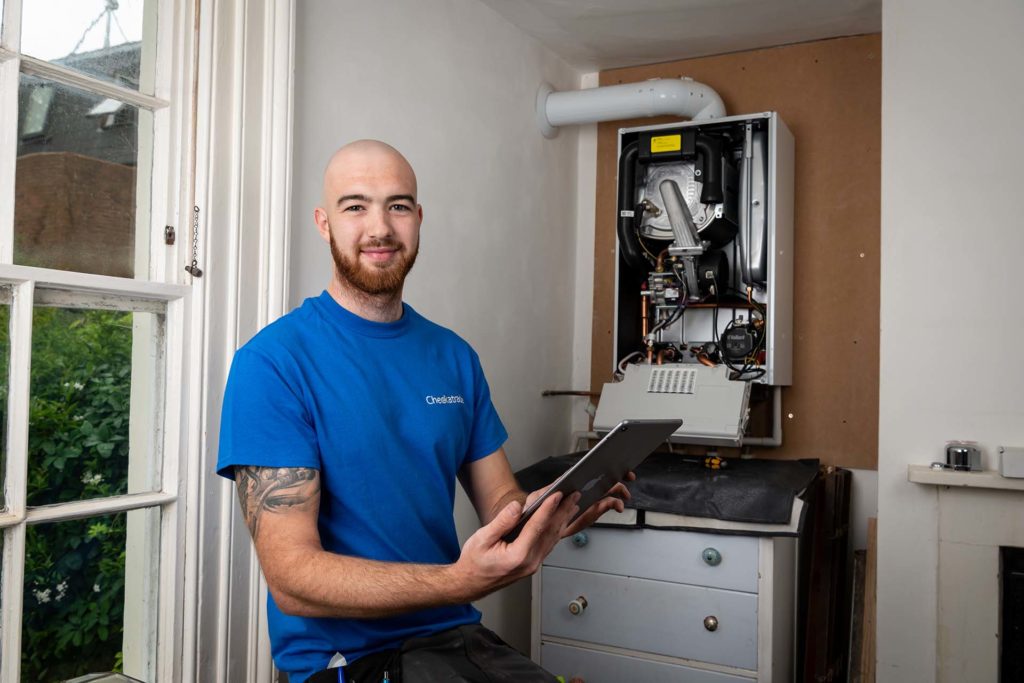 Engineer fixing a boiler not working after power cut