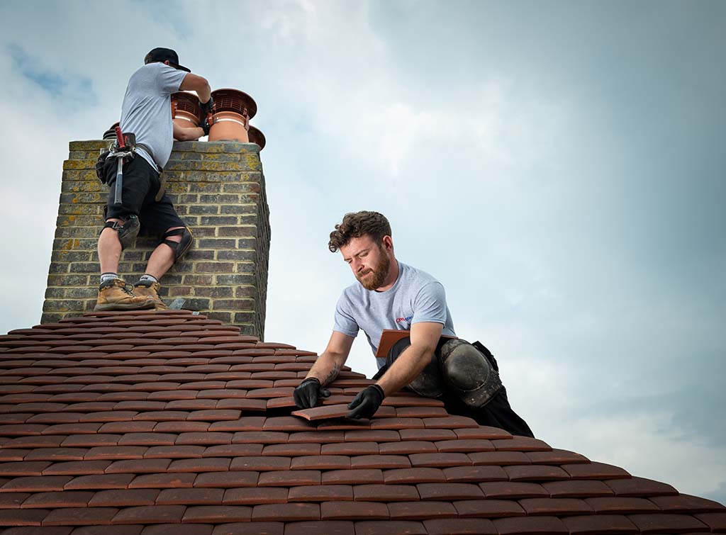 What homeowners want in November - roofing firm checking integrity of chimney