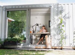 Female worker sat in her garden office room