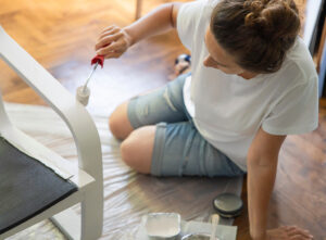 Woman painting furniture white