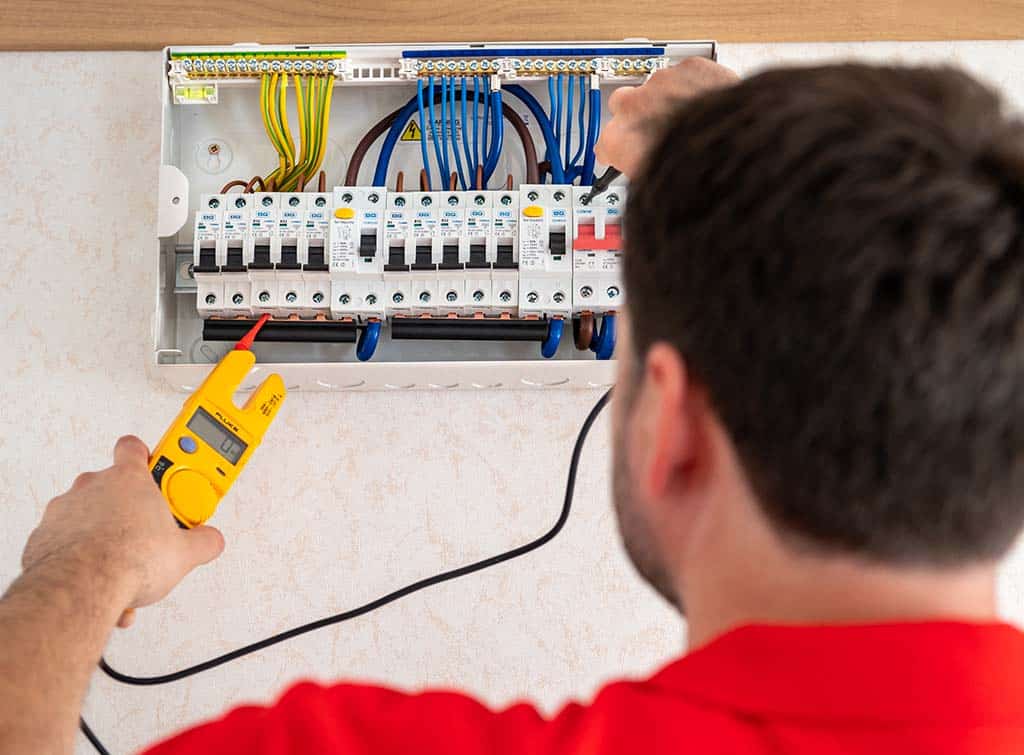 A Checkatrade electrician working on a consumer unit