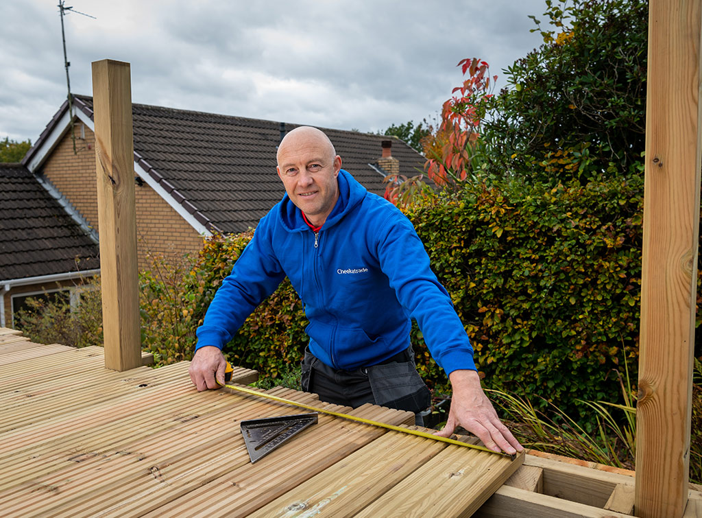 Checkatrade carpenter installing garden decking