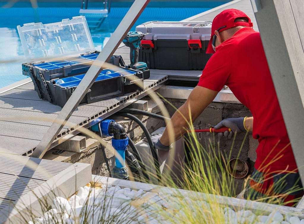 Pool maintenance near me - man fixing a pool