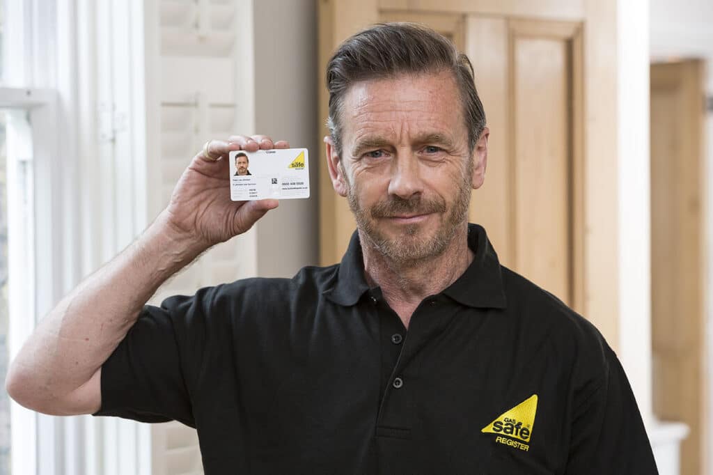 Gas Safe engineer presenting ID card