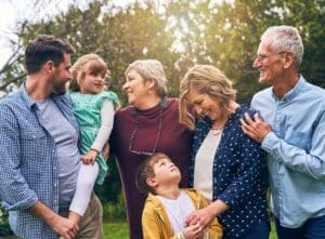 Multigenerational family together in the garden, smiling