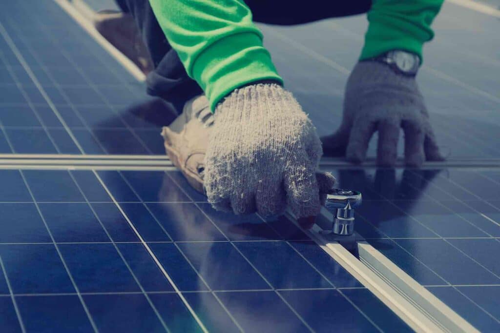 Qualified solar panel maintenance technician at work
