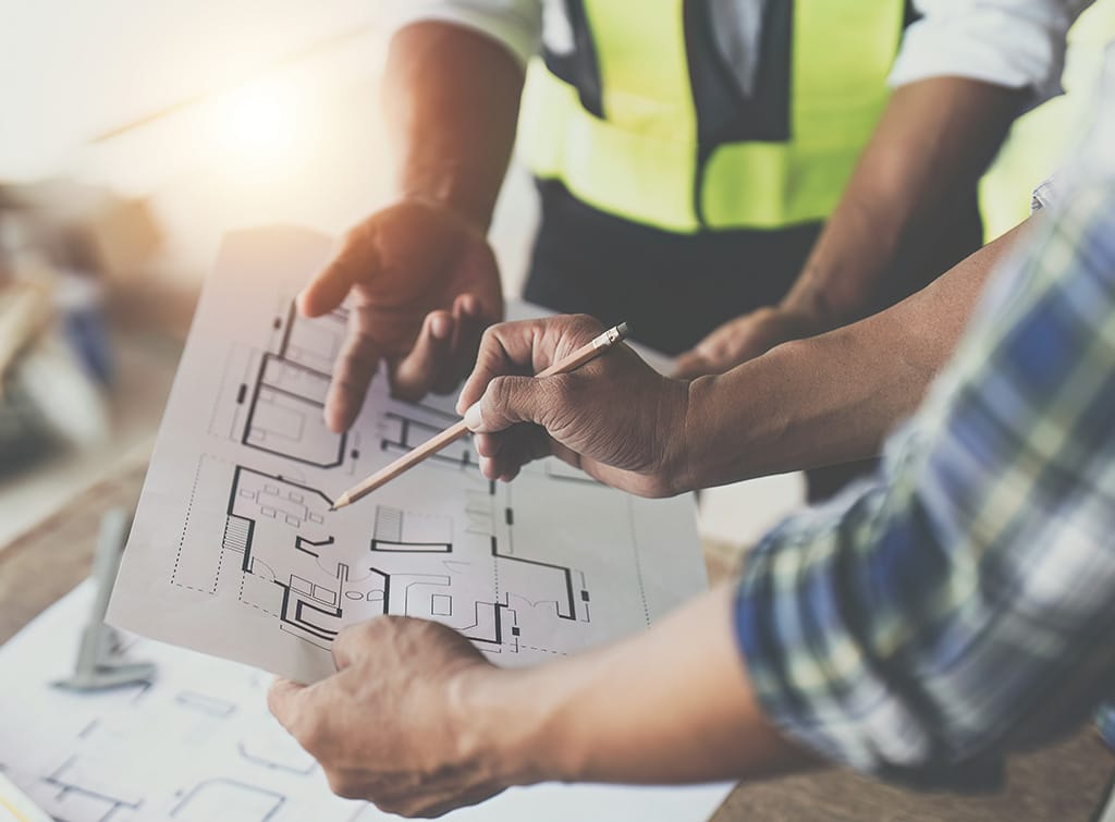 structural engineer and builder looking over drawings