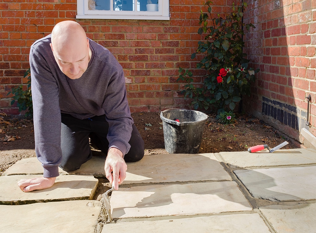 Man laying patio slabs
