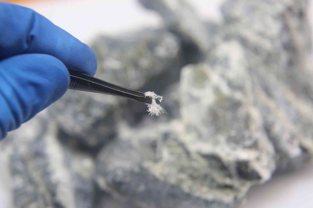 Tradesperson showing asbestos fibres