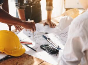 architect and structural engineer reviewing construction plans