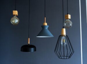 A selection of hanging pendant lights against a navy wall