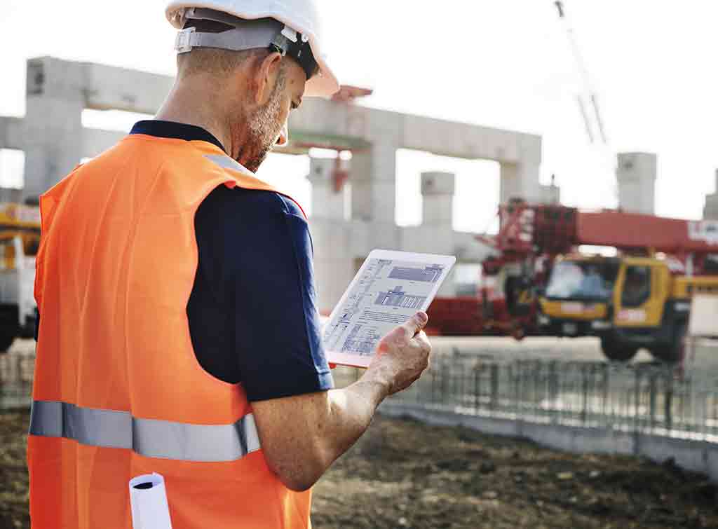 Tradesperson overseeing crane in operation