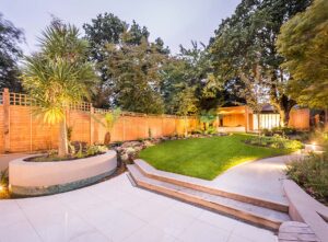 Garden lighting illuminating a back garden at dusk