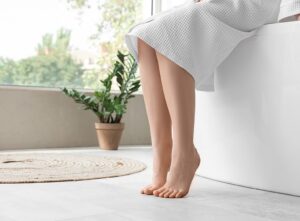 Bare feet on bathroom floor with underfloor heating