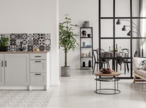 Grey vinyl floor next to grey laminate floor in an open plan kitchen lounge diner